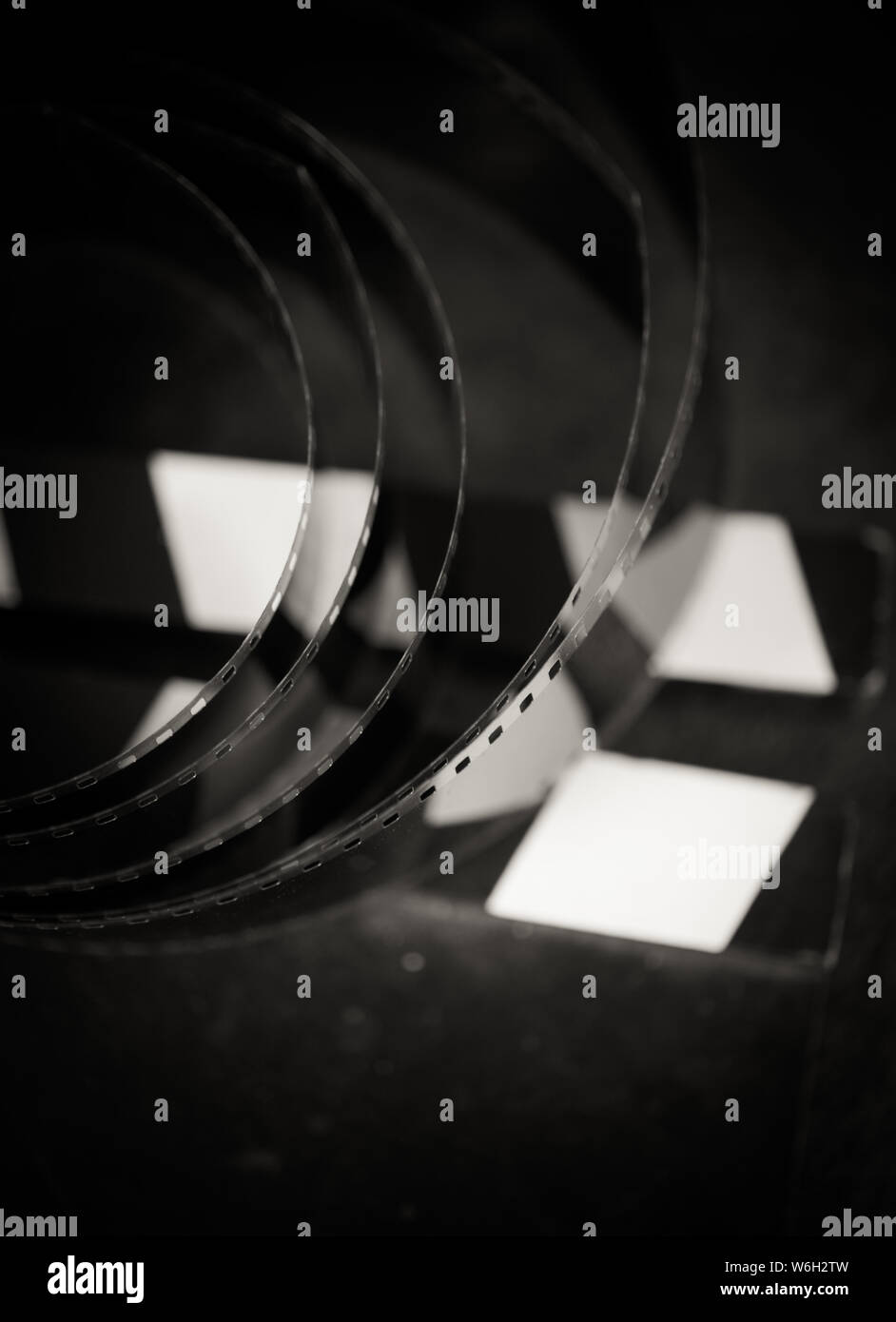 Extreme close up of filmstrip on  movie slate selective focus on foreground black and white vintage old fashioned Stock Photo