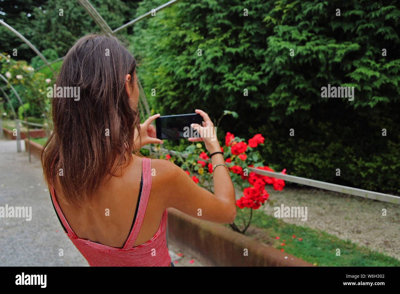Young girl taking some pictures with her cell phone. Stock Photo