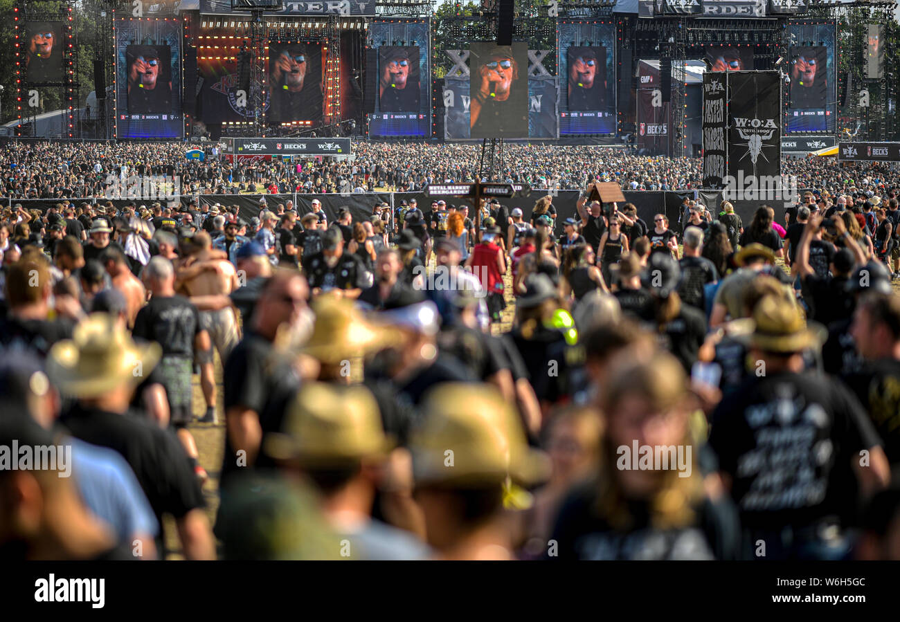 Wacken, Germany. 01st Aug, 2019. Visitors of the WOA - Wacken Open Air  celebrate in front of the stages. The WOA is regarded as the largest heavy  metal festival in the world.