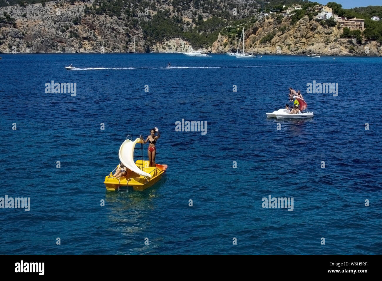MALLORCA, SPAIN - JUNE 23, 2019: Girl on rented toy boat near coast on a sunny day on June 23, 2019 in Mallorca, Spain. Stock Photo