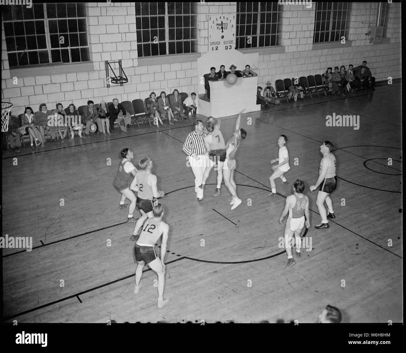 Granada Relocation Center, Amache, Colorado. A hotly contested basket ball  game between the Granada . . .; Scope and content: The full caption for  this photograph reads: Granada Relocation Center, Amache, Colorado.