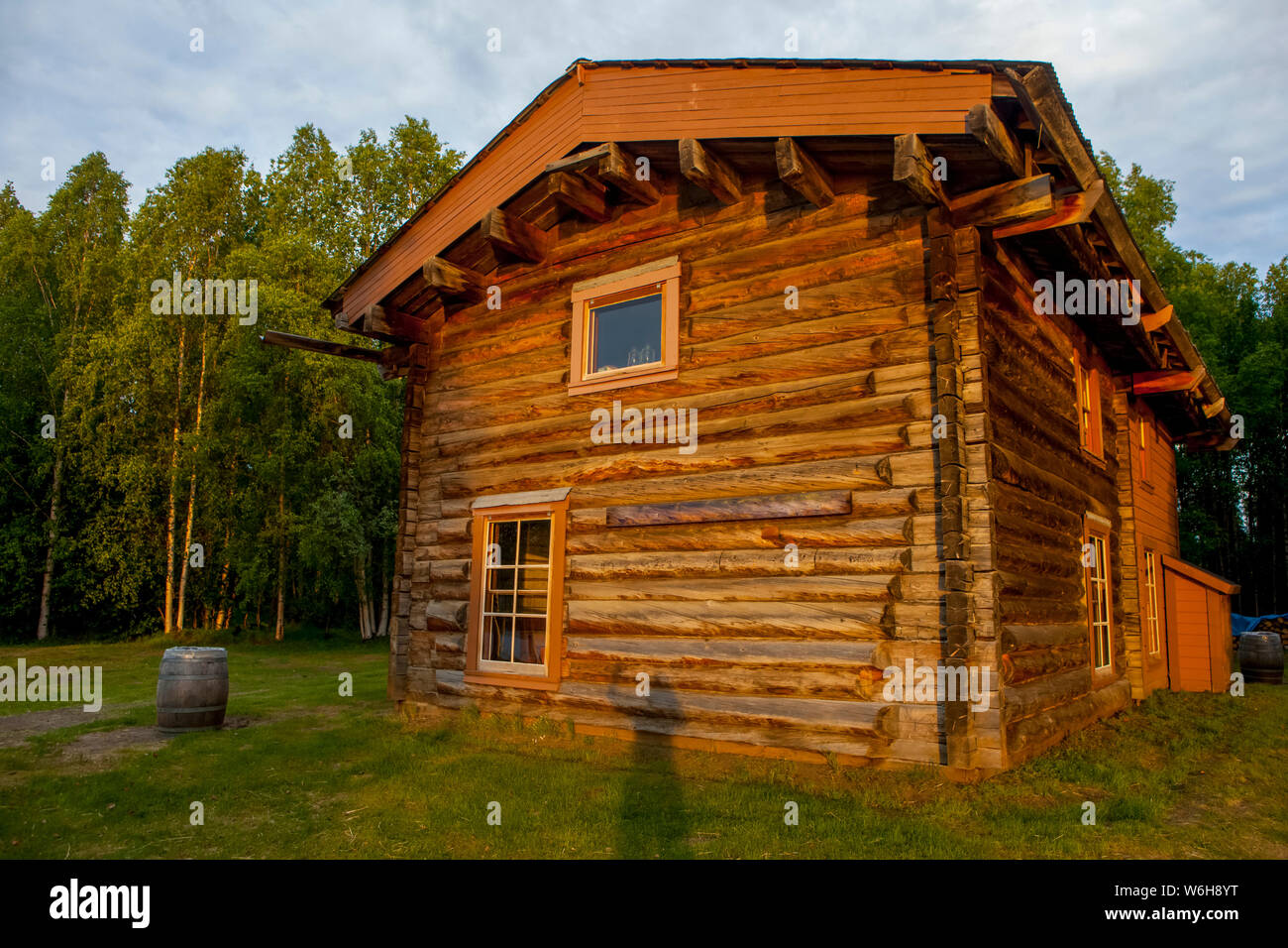 Slaven's Roadhouse, on a sunny, summer night with shadow of person waving, Yukon–Charley Rivers National Preserve Stock Photo