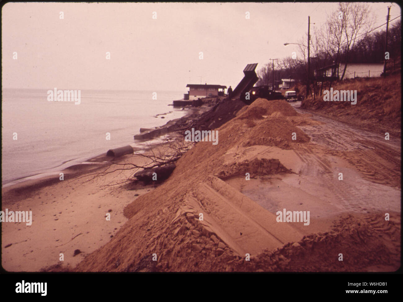 HOUSE IN BACKGROUND IS THREATENED BY BEACH EROSION. U.S ARMY CORPS OF ENGINEERS PROVIDED DIRT BULWARK IN FOREGROUND Stock Photo