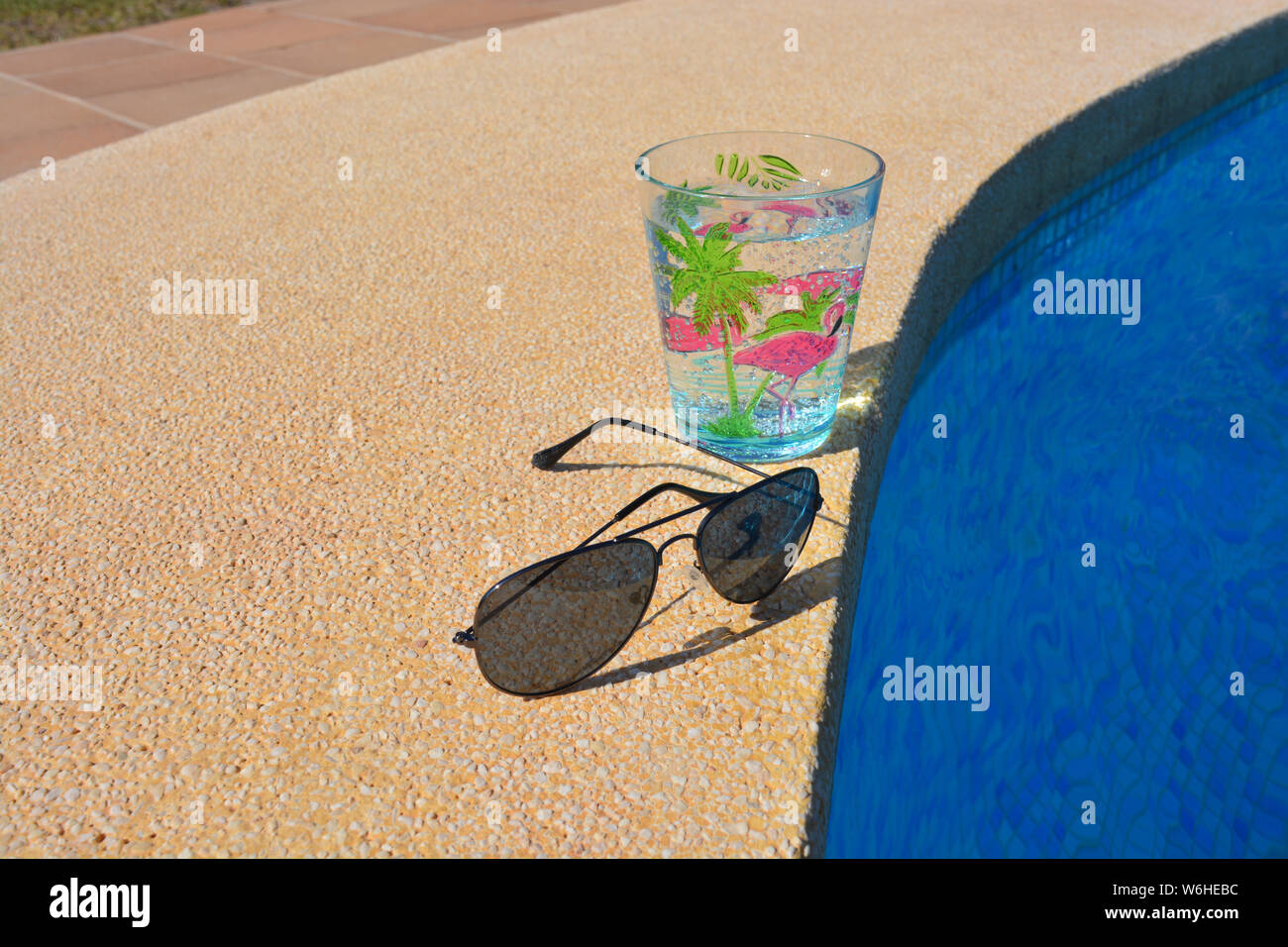 Summer vibes, metal framed dark sunglasses and a drink in a decorated