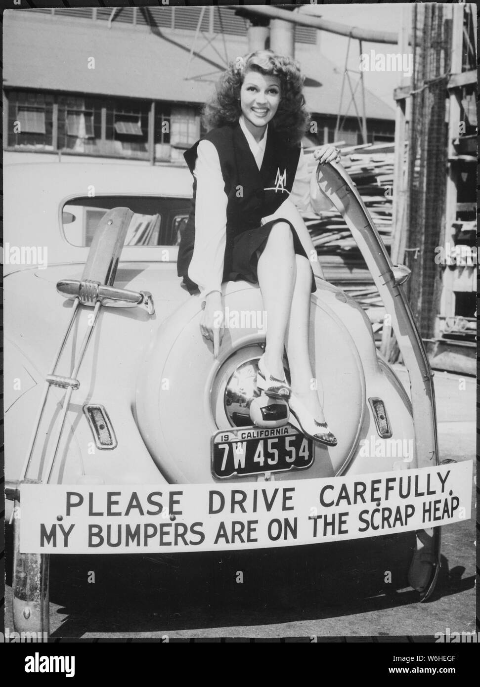 Harvesting bumper crop for Uncle Sam. Movie star Rita Hayworth sacrificed her bumpers for the duration. Besides setting an example by turning in unessential metal car parts, Miss Hayworth has been active in selling war bonds., 1942 Stock Photo