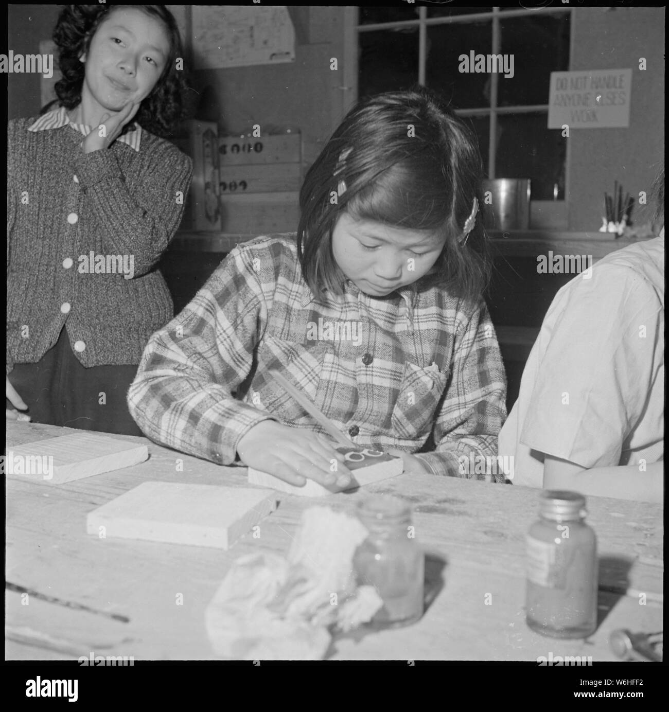 Heart Mountain Relocation Center, Heart Mountain, Wyoming. A young enthusiast working on a pair of . . .; Scope and content:  The full caption for this photograph reads: Heart Mountain Relocation Center, Heart Mountain, Wyoming. A young enthusiast working on a pair of book ends in a center craft shop. Craft shops are popular recreation for old as well as young residents of Japanese ancestry at this relocation center. Stock Photo