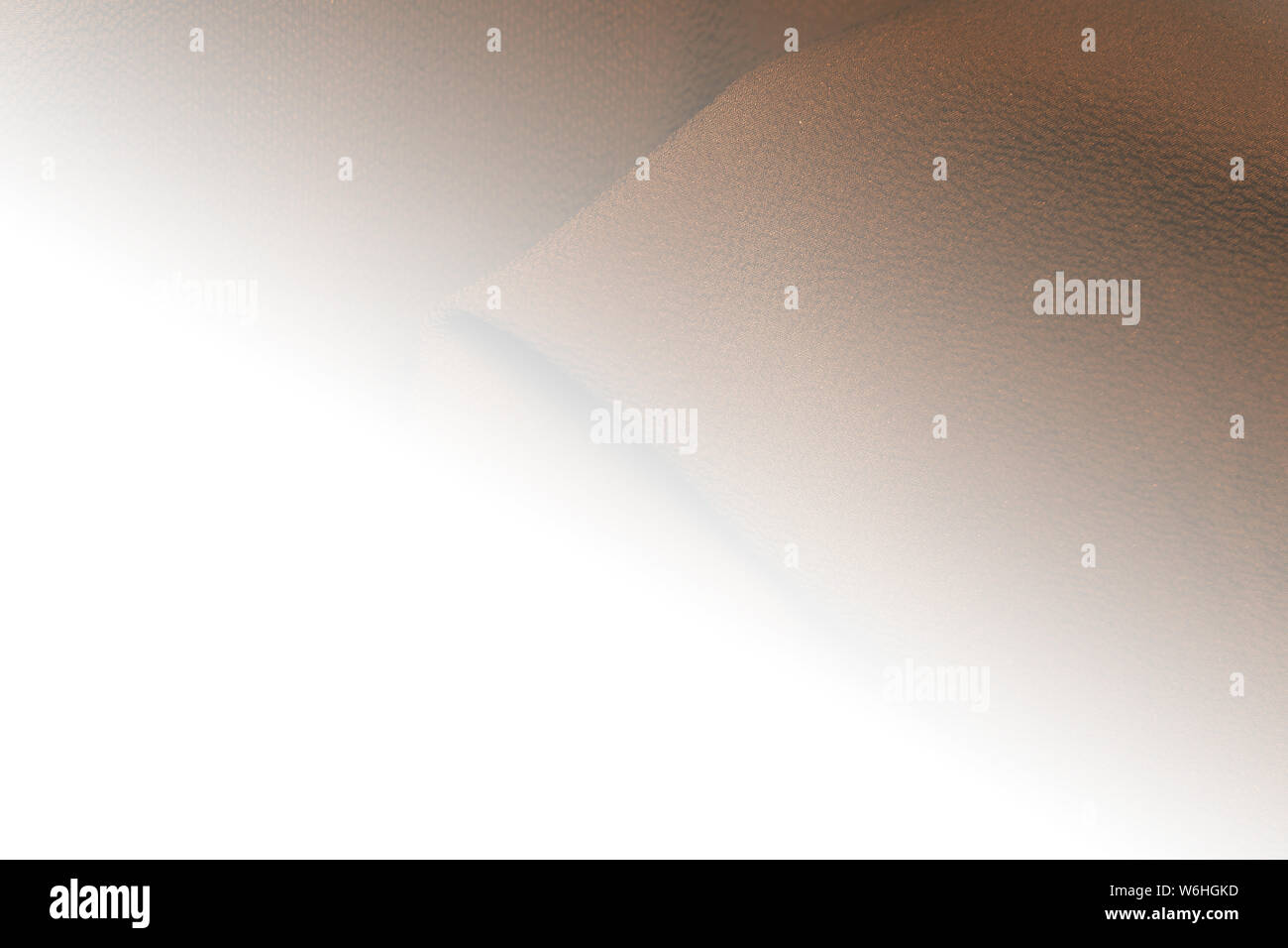 Brown fabric background with white glow , space for text Stock Photo