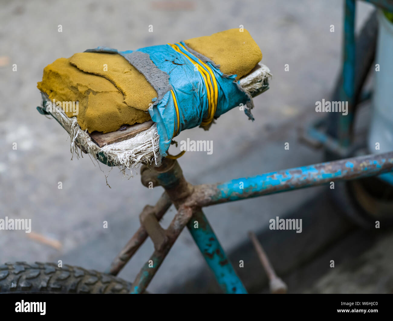 Bicycle seat in disrepair, patched with tape over worn foam on a very old bicycle; Havana, Cuba Stock Photo