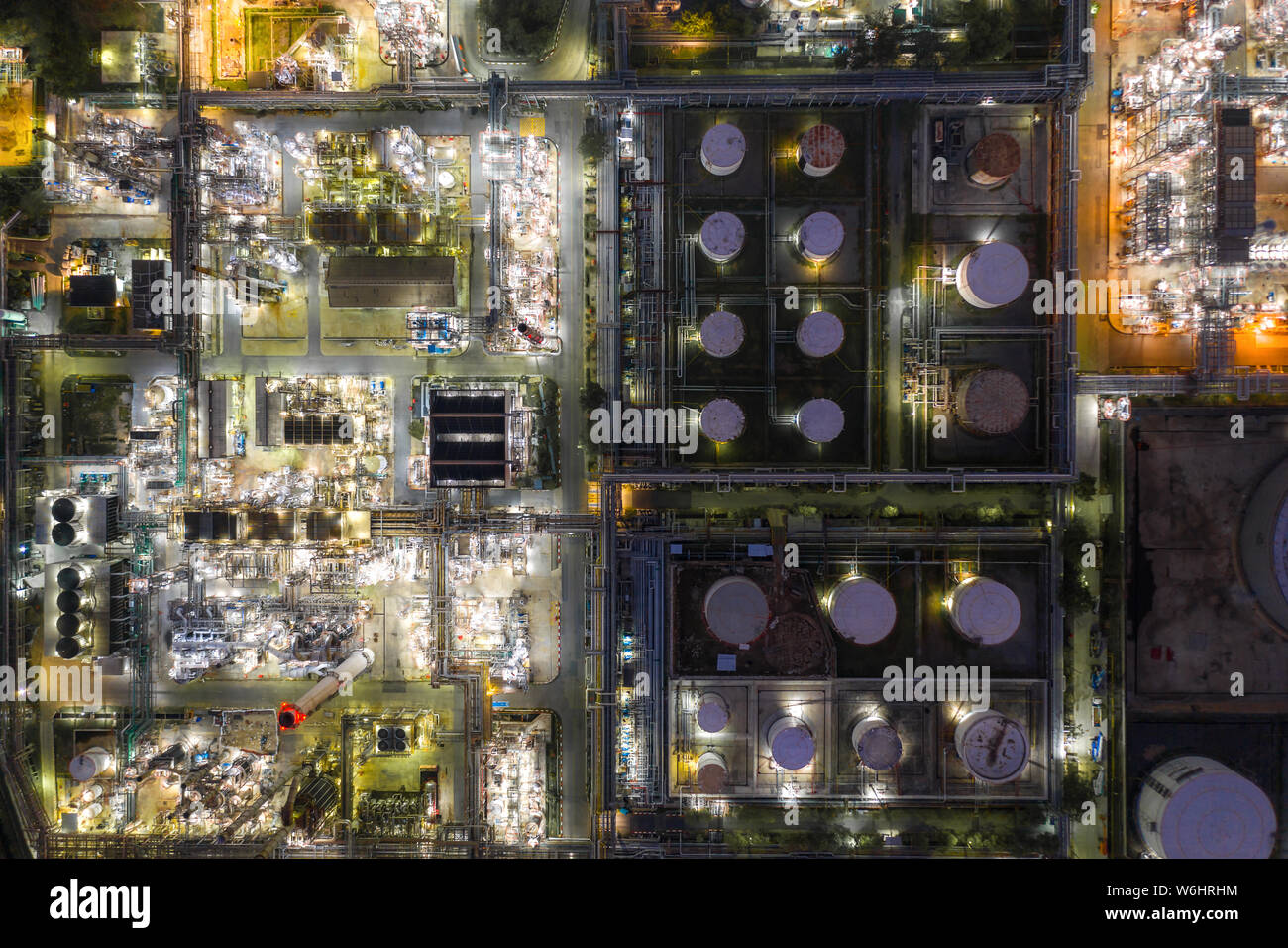 Aerial view oil refinery and gas refinery plant form industry zone at night. Stock Photo