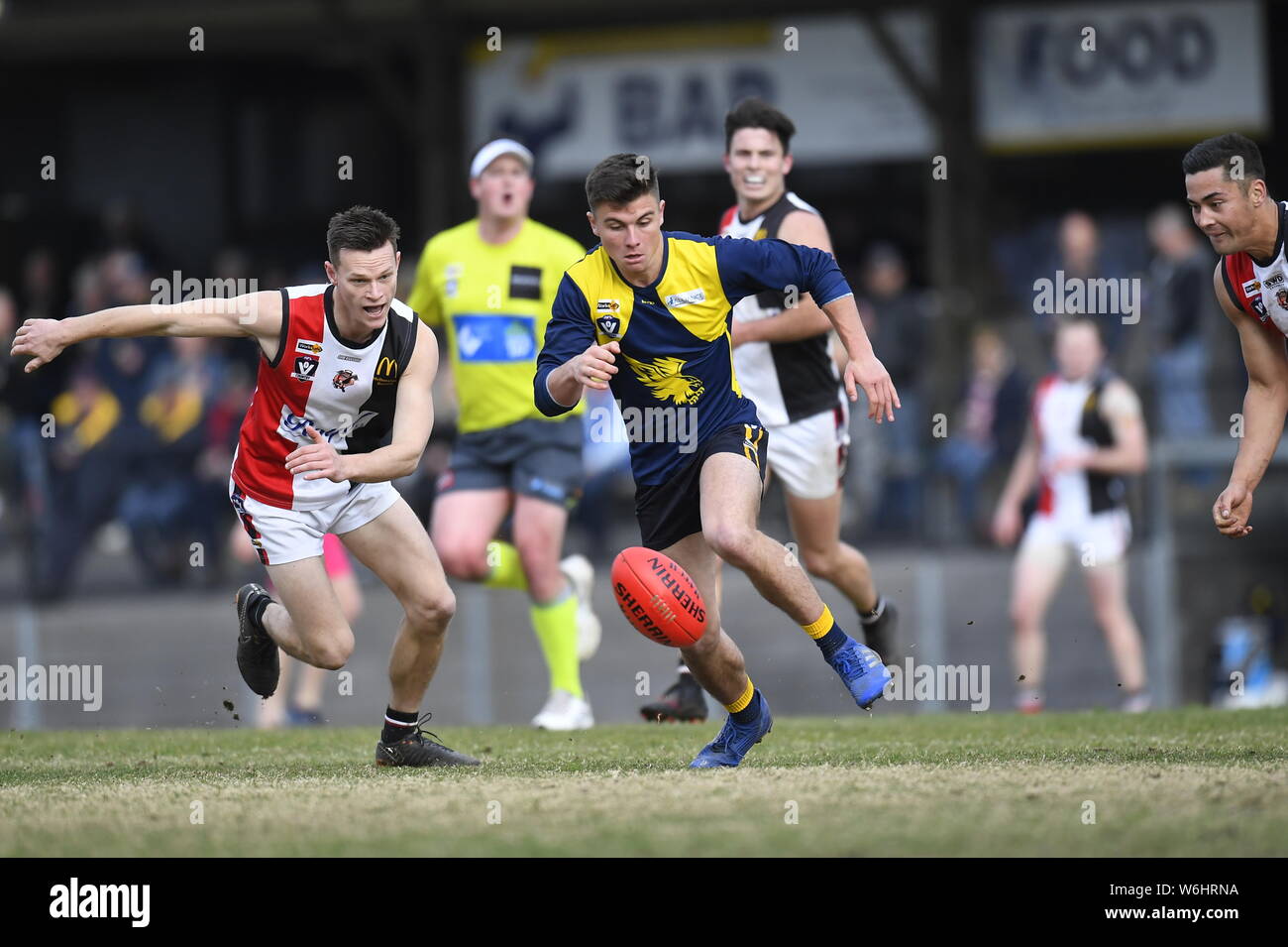Charging for the footie, Benalla take on Mansfield in the Goulburn Valley Football League. Grass roots footy is popular in regional Australia Stock Photo