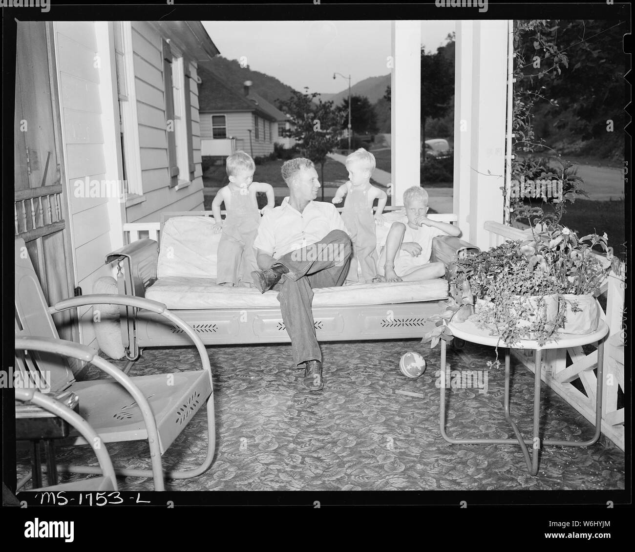 James Jasper, motor brakeman, with his three children on front porch of their home in company housing project. Koppers Coal Division, Kopperston Mine, Kopperston, Wyoming County, West Virginia. Stock Photo