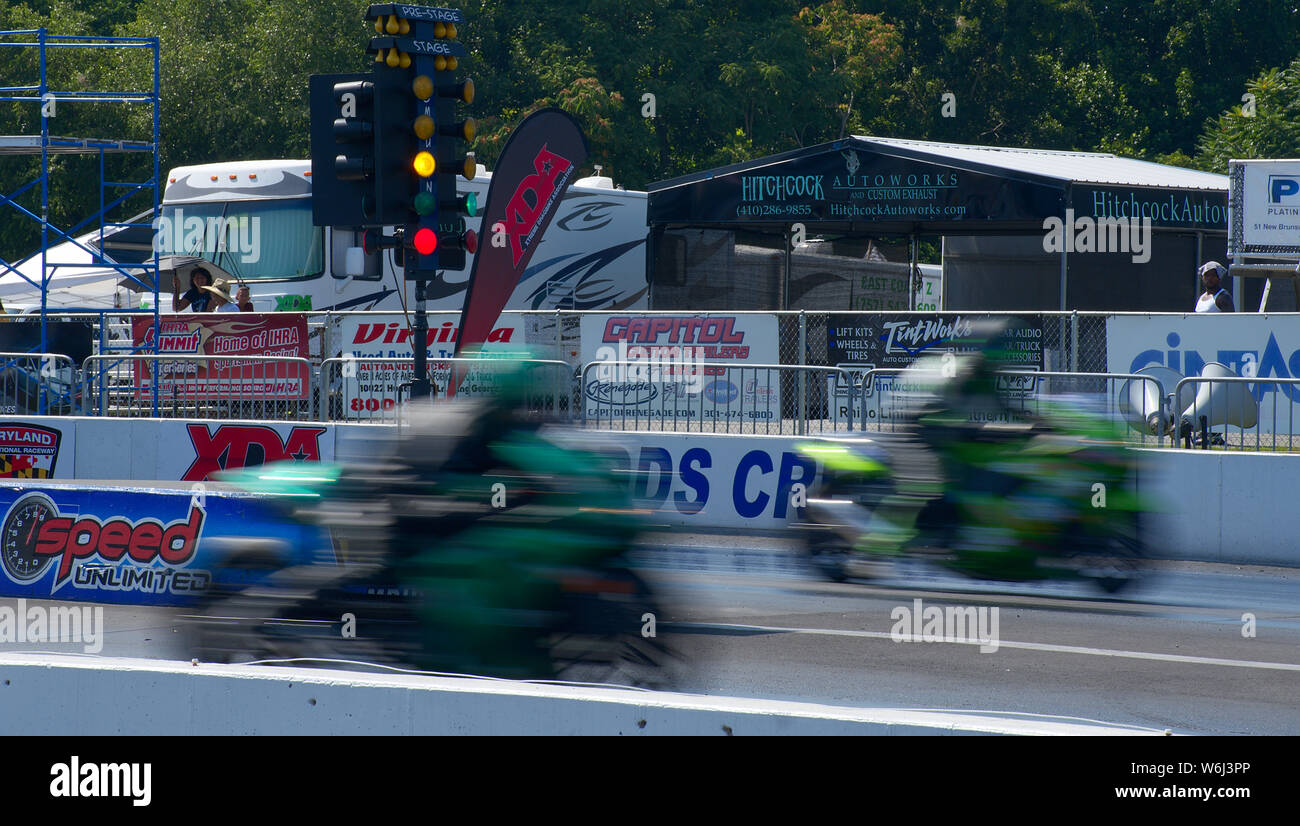 Two motorcycles during drag race at Maryland National Raceway slow ...
