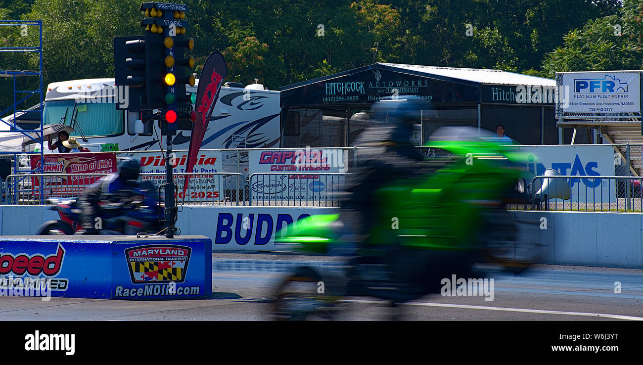 Two motorcycles during drag race at Maryland National Raceway slow ...