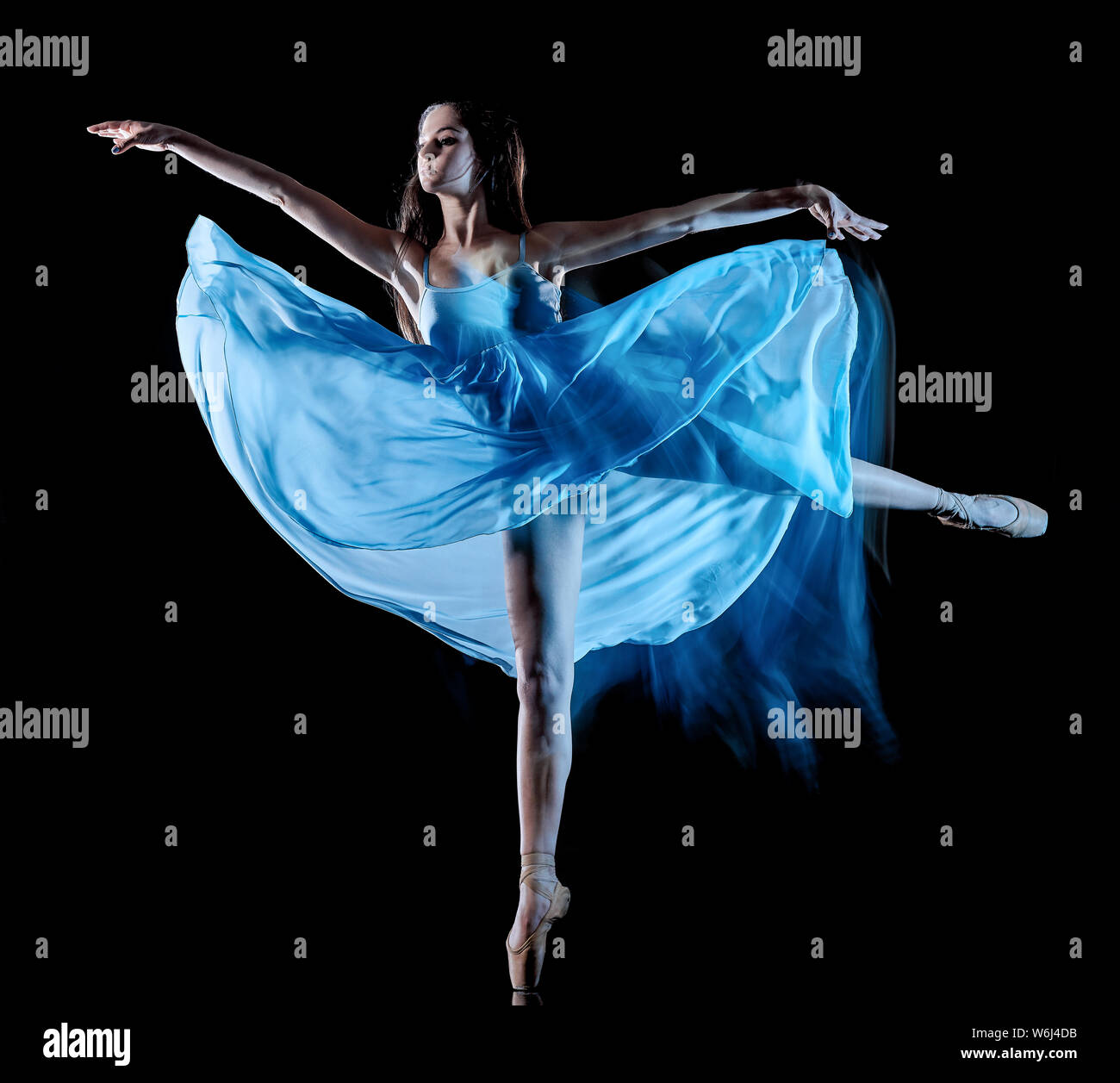 one caucasian young woman ballet dancer dancing isolated on black background with  light painting motion blur speed effect Stock Photo
