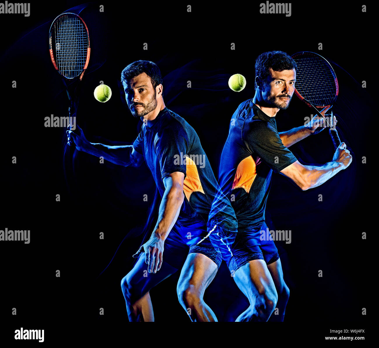 one caucasian Tennis player man studio shot isolated on black background with light painting blur effect Stock Photo