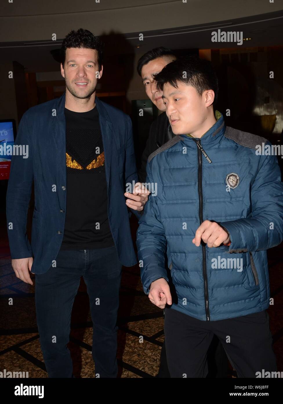retired-german-football-player-michael-ballack-takes-photos-with-a-fan