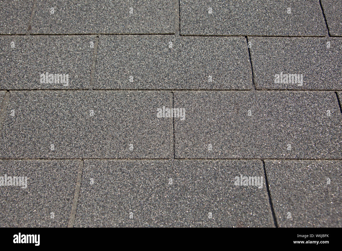 Background of grey or charcoal colored roof tiles making a pattern Stock Photo