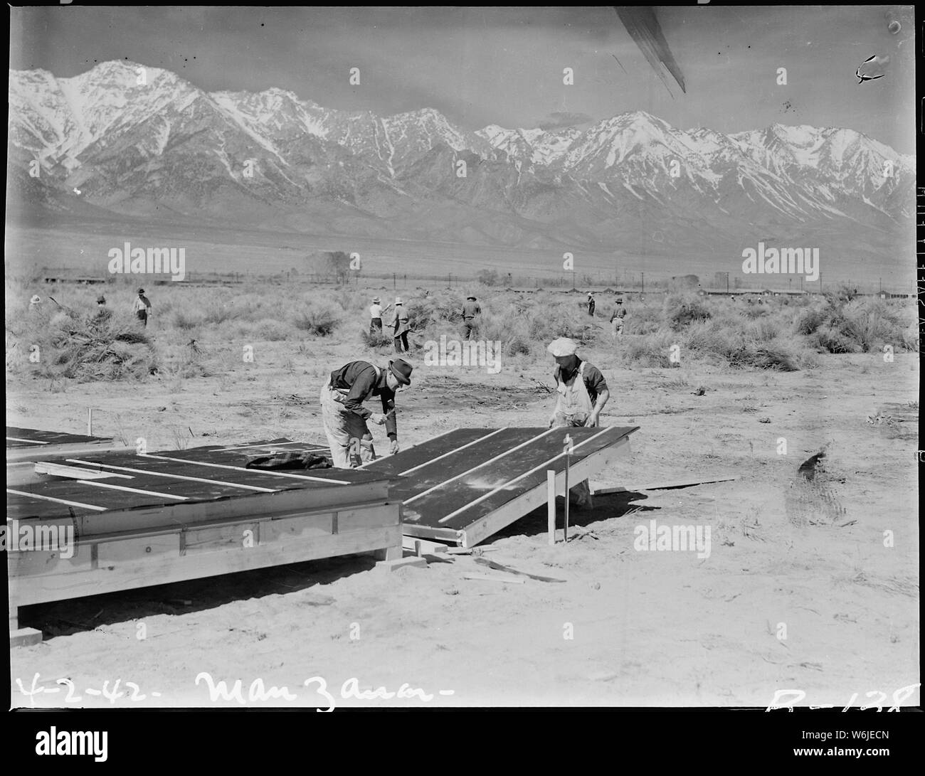 Manzanar Relocation Center, Manzanar, California. Construction begins at Manzanar, now a War Reloca . . .; Scope and content:  The full caption for this photograph reads: Manzanar Relocation Center, Manzanar, California. Construction begins at Manzanar, now a War Relocation Authority center for evacuees of Japanese ancestry, in Owens Valley, flanked by the High Sierras and Mount Whitney, loftiest peak in the United States. Stock Photo