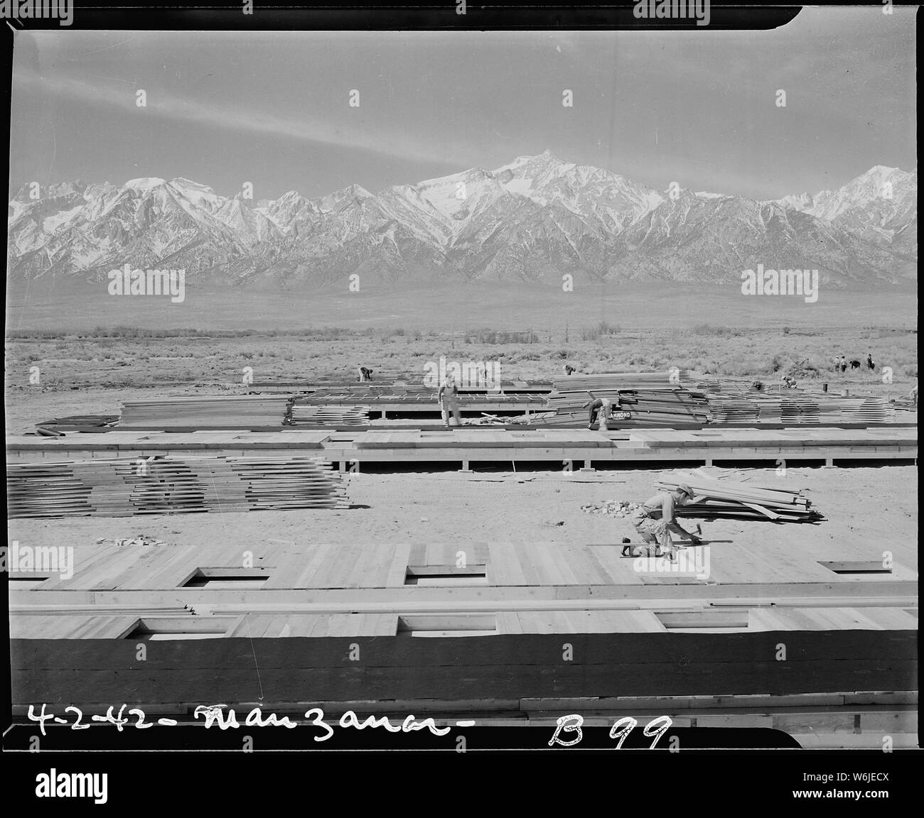 Manzanar Relocation Center, Manzanar, California. Construction begins at Manzanar, now a War Reloca . . .; Scope and content:  The full caption for this photograph reads: Manzanar Relocation Center, Manzanar, California. Construction begins at Manzanar, now a War Relocation Authority center for evacuees of Japanese ancestry, in Owens Valley, flanked by the High Sierras and Mount Whitney, loftiest peak in the United States. Stock Photo