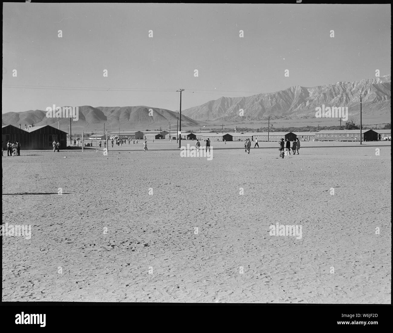 Manzanar Relocation Center, Manzanar, California. Looking southwest across the wide fire-break at t . . .; Scope and content:  The full caption for this photograph reads: Manzanar Relocation Center, Manzanar, California. Looking southwest across the wide fire-break at this War Relocation Authority center which houses 10,000 evacuees of Japanese ancestry. It is located in Owens Valley between the High Sierras and Mount Whitney, the highest peak in the United States. Stock Photo