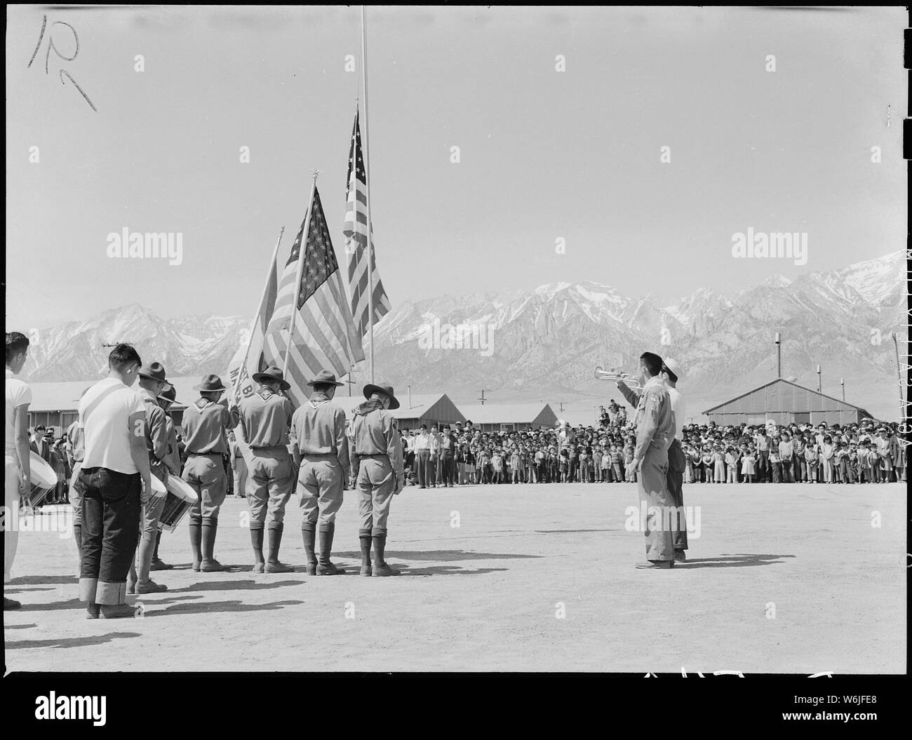 Manzanar Relocation Center, Manzanar, California. Taps at Memorial Day services at Manzanar, a War . . .; Scope and content:  The full caption for this photograph reads: Manzanar Relocation Center, Manzanar, California. Taps at Memorial Day services at Manzanar, a War Relocation Authority center for evacuees of Japanese ancestry. Boy Scouts and American Legion members participated in the services. Stock Photo