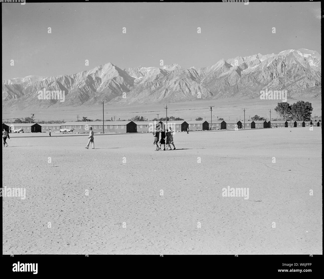 Manzanar Relocation Center, Manzanar, California. This War Relocation Authority center which houses . . .; Scope and content:  The full caption for this photograph reads: Manzanar Relocation Center, Manzanar, California. This War Relocation Authority center which houses 10,00 evacuees of Japanese ancestry is located in Owens Valley between the High Sierras and Mount Whitney, the highest peak in the United States. The space in the forground is a wide fire-break between blocks of barracks which aslo serves as a playfield. Stock Photo