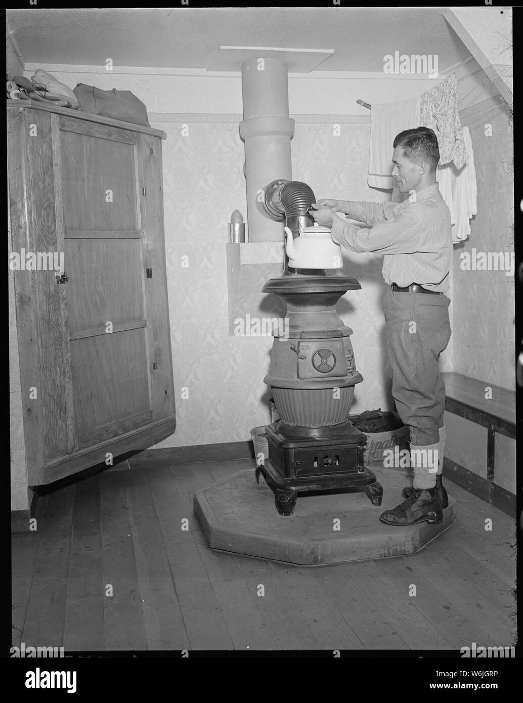 Minidoka Relocation Center. Eizo Nishi. View in the home of Eizo Nishi. The pot bellied stove sho . . .; Scope and content:  The full caption for this photograph reads: Minidoka Relocation Center. Eizo Nishi. View in the home of Eizo Nishi. The pot bellied stove shown in this photo burns coal and provides ample heat. Stock Photo