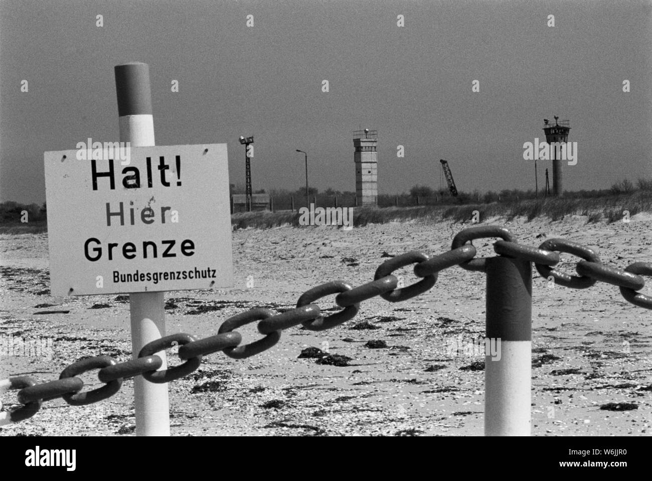Inner-German border at the Baltic Sea, A chain and signs on the beach of, Two watchtowers are occupied day and night with border guards. Stock Photo