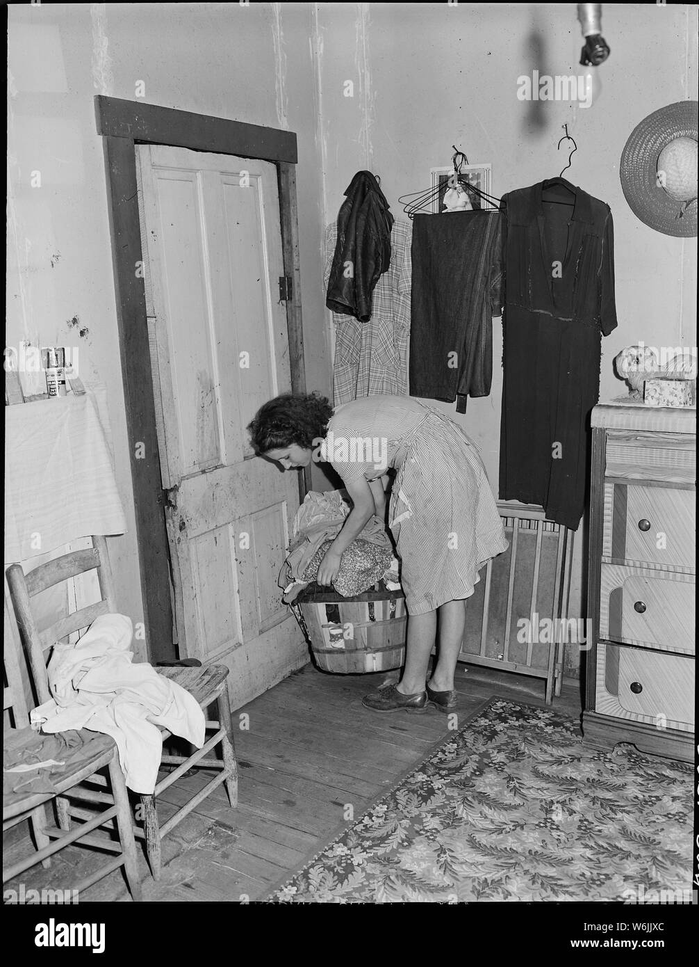 Mrs. Lincoln Hagg, wife of miner, in the bedroom of her house 