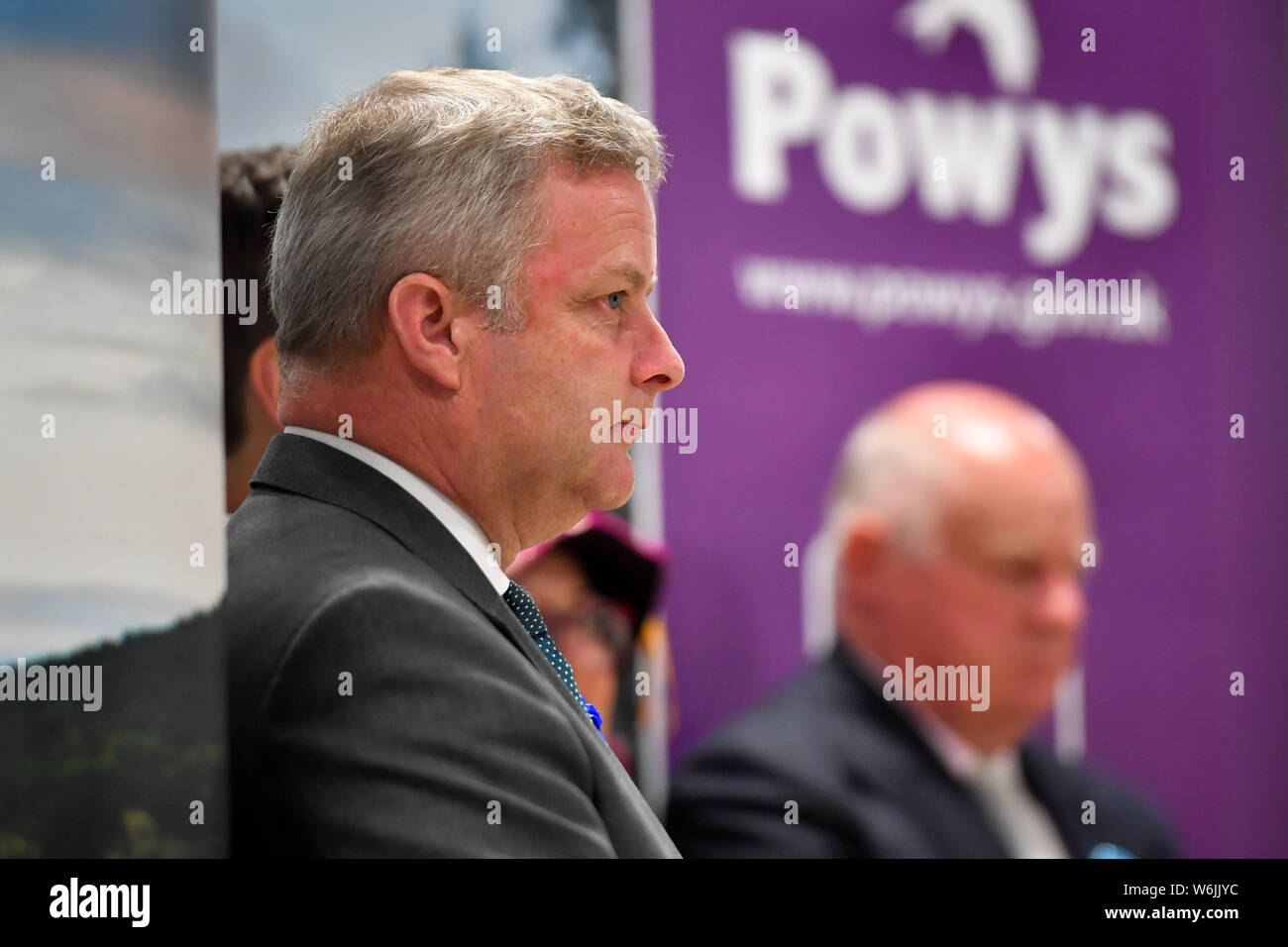 Conservative candidate Chris Davies on the stage as Liberal Democrats MP Jane Dodds speaks after winning the seat in the Brecon and Radnorshire by-election at the Royal Welsh Showground, Llanelwedd, Builth Wells. Stock Photo