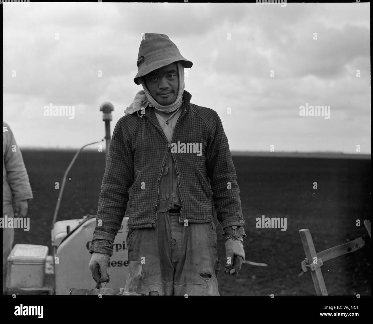 Near Stockton, California. Field laborer of Japanese ancestry on a large-scale corporation ranch a . . .; Scope and content:  The full caption for this photograph reads: Near Stockton, California. Field laborer of Japanese ancestry on a large-scale corporation ranch a few days prior to evacuation. These laborers earned from $750.00 to $1000 per year, plus living accomodations and their own little gardens. Stock Photo