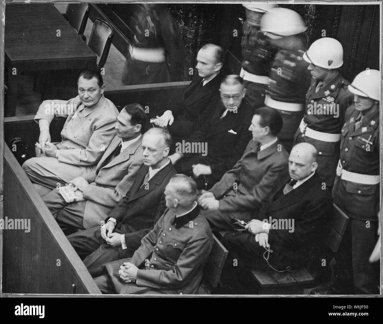 Nuremberg Trials. Defendants in their dock; Goering, Hess, von Ribbentrop, and Keitel in front row, circa 1945-1946., ca. 1945 - ca. 1946; General notes:  Use War and Conflict Number 1297 when ordering a reproduction or requesting information about this image. Stock Photo