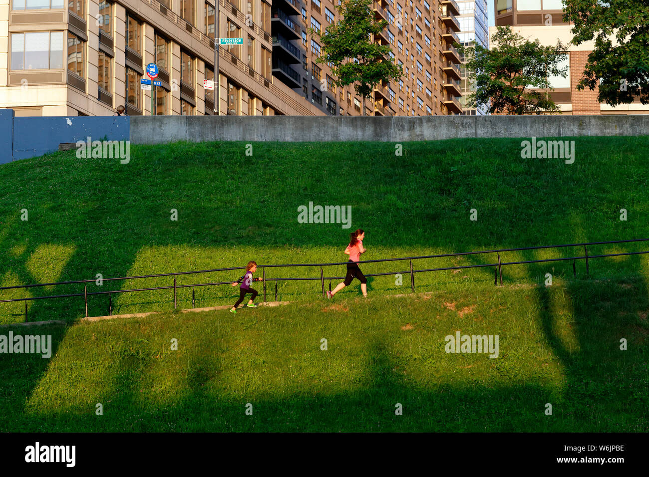 Joggers run up a hill in Riverside Park to reach Riverside Terrace in Manhattan, New York, NYC Stock Photo