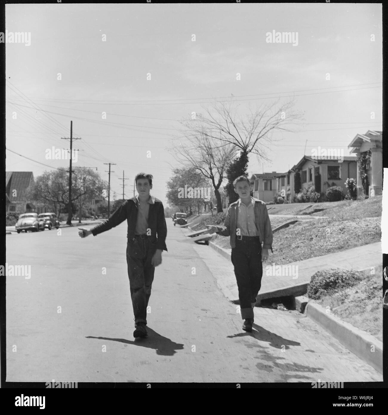 Oakland, California. Hitchhiking. Thumbing is used as a means of