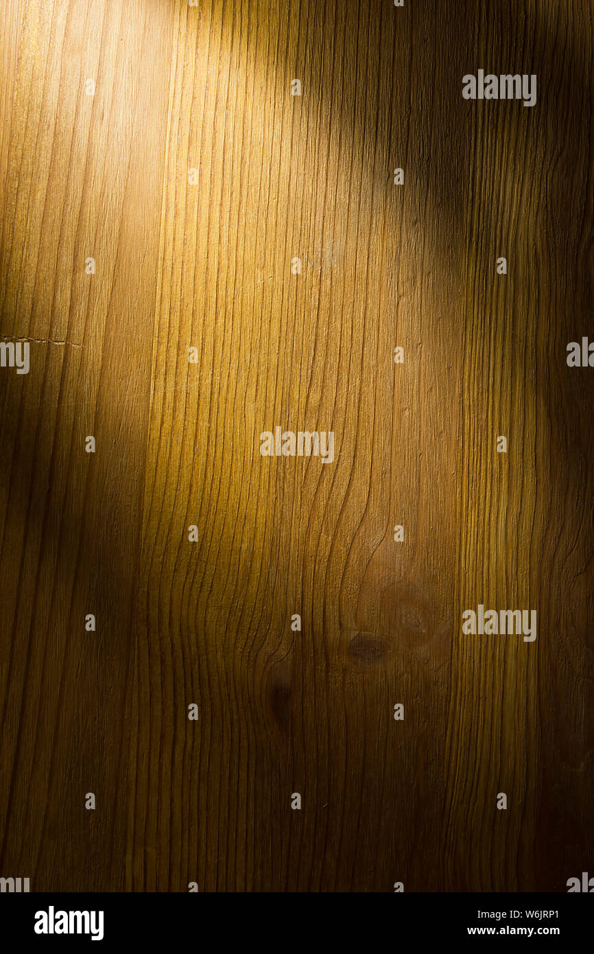 Brown natural wooden background lit by a ray of light Stock Photo
