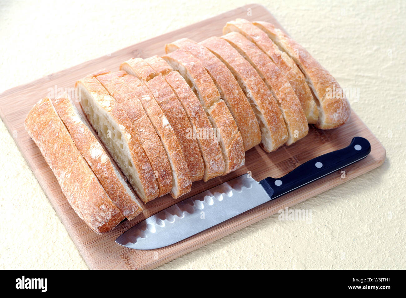 sliced ciabatta flat bread and knife on cutting board Stock Photo Alamy