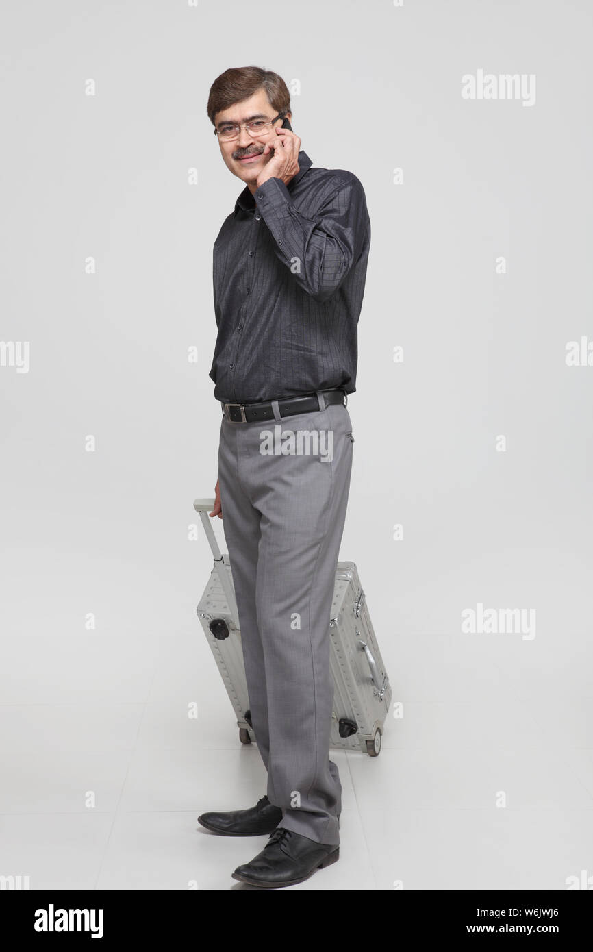 Old man walking phone hi-res stock photography and images - Alamy