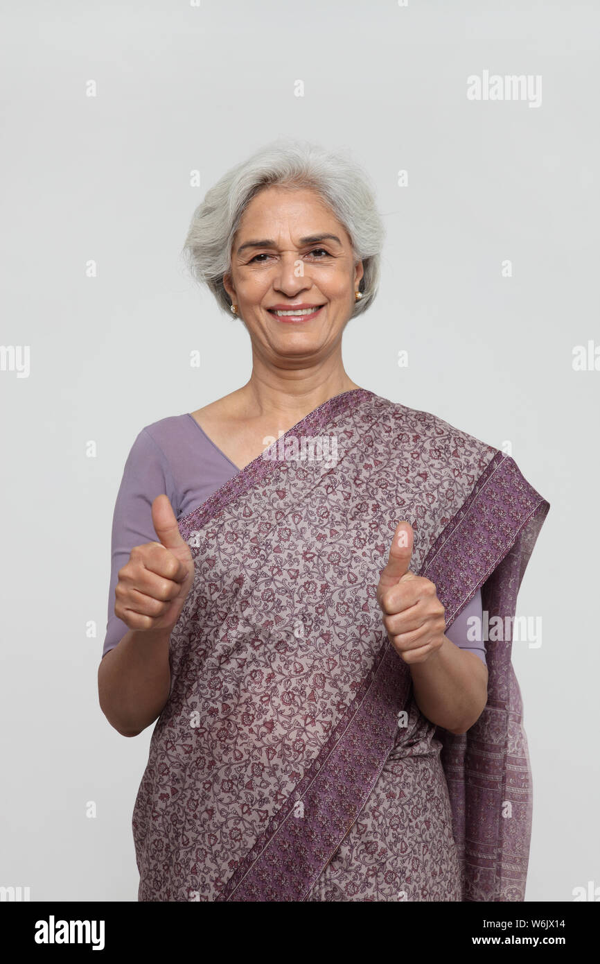 Woman showing thumbs up sign hi-res stock photography and images - Alamy