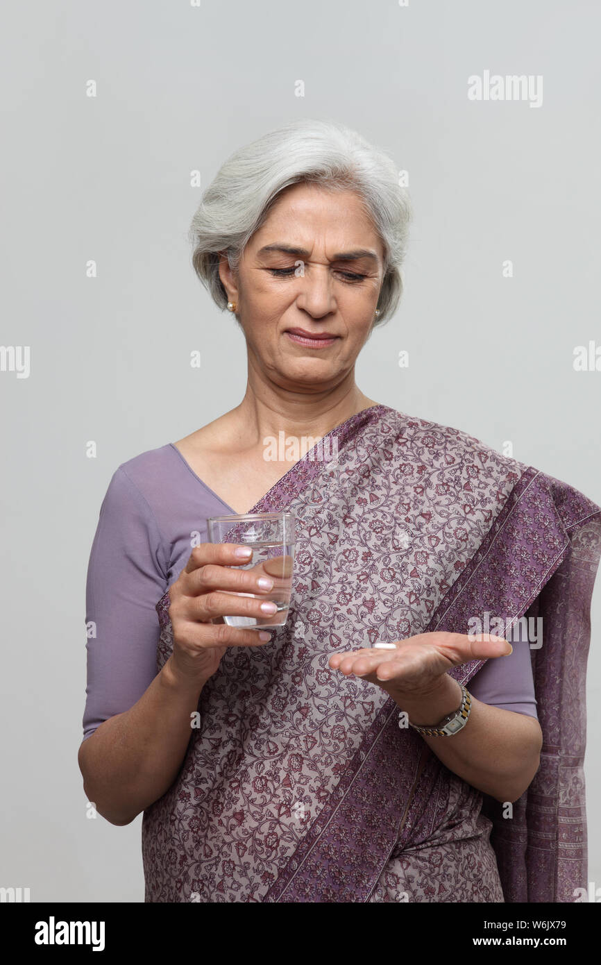Old woman taking medicine Stock Photo Alamy