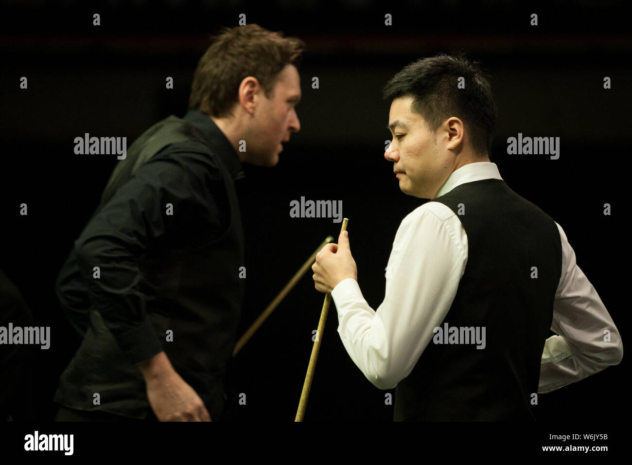 Ding Junhui of China, right, interacts with Ricky Walden of England in their second round match during the 2018 D88 German Masters snooker tournament Stock Photo