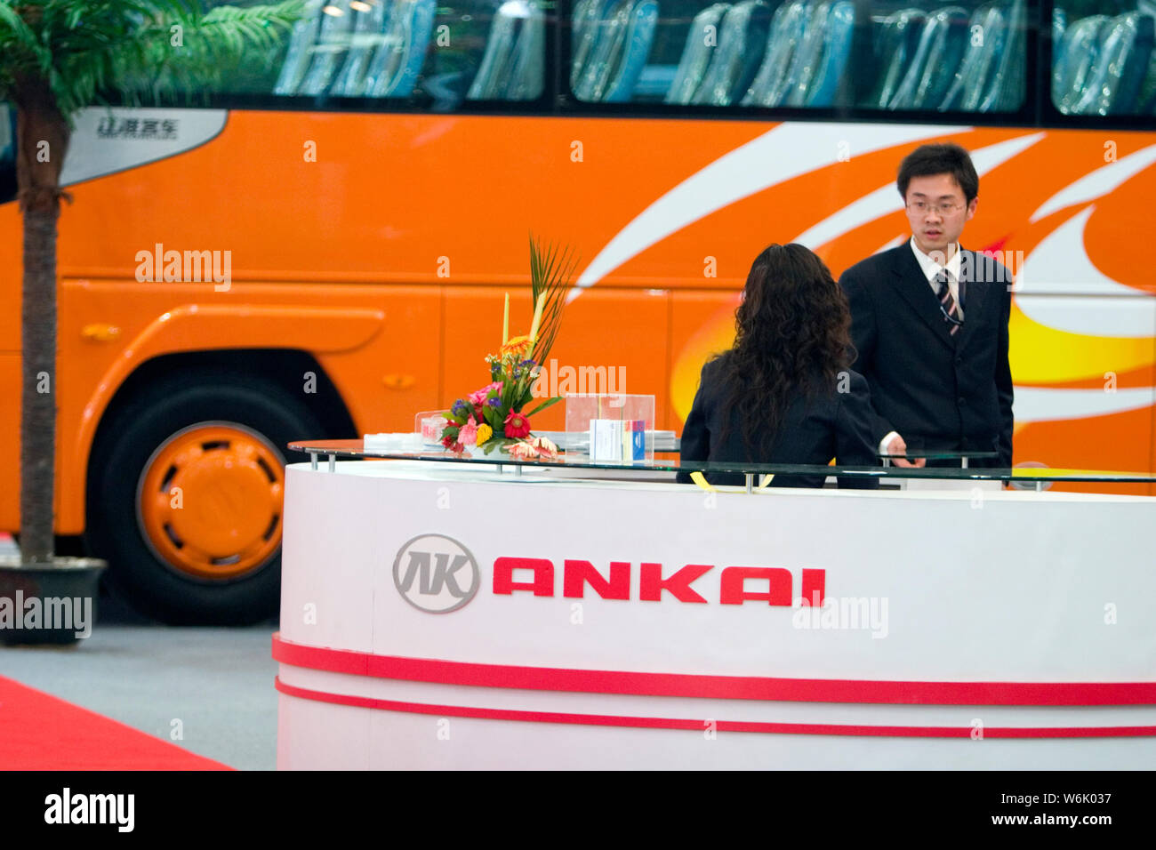 --FILE--Employees are pictured at the stand of Anhui Ankai Automobile during an exhibition in Shanghai, China, 13 March 2008.   Anhui Ankai Automobile Stock Photo