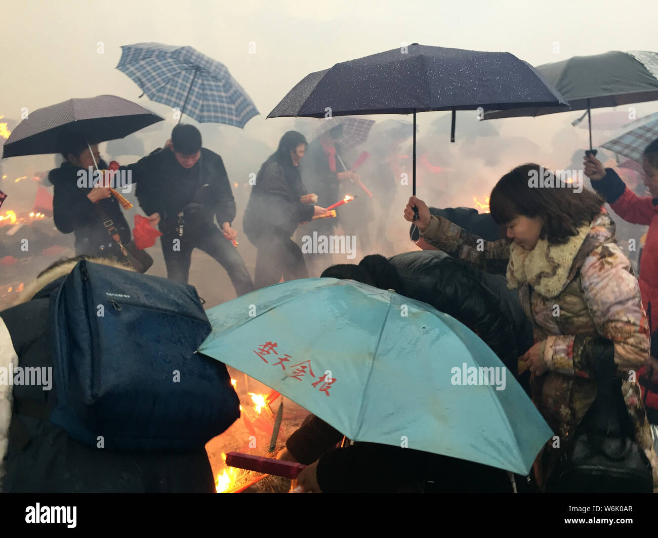 Chinese worshippers burn incense sticks to pray for wealth and ...