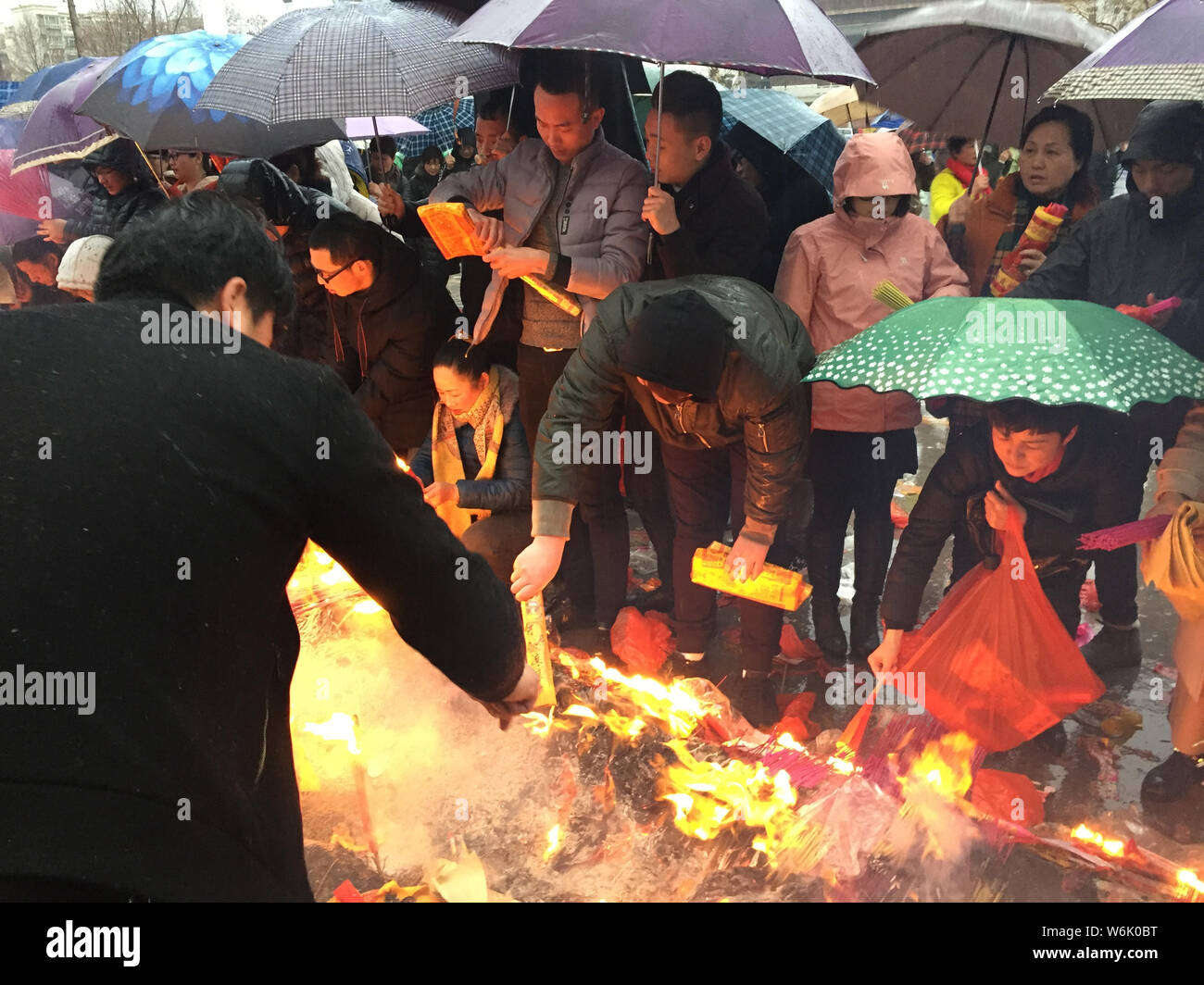 Chinese worshippers burn incense sticks to pray for wealth and