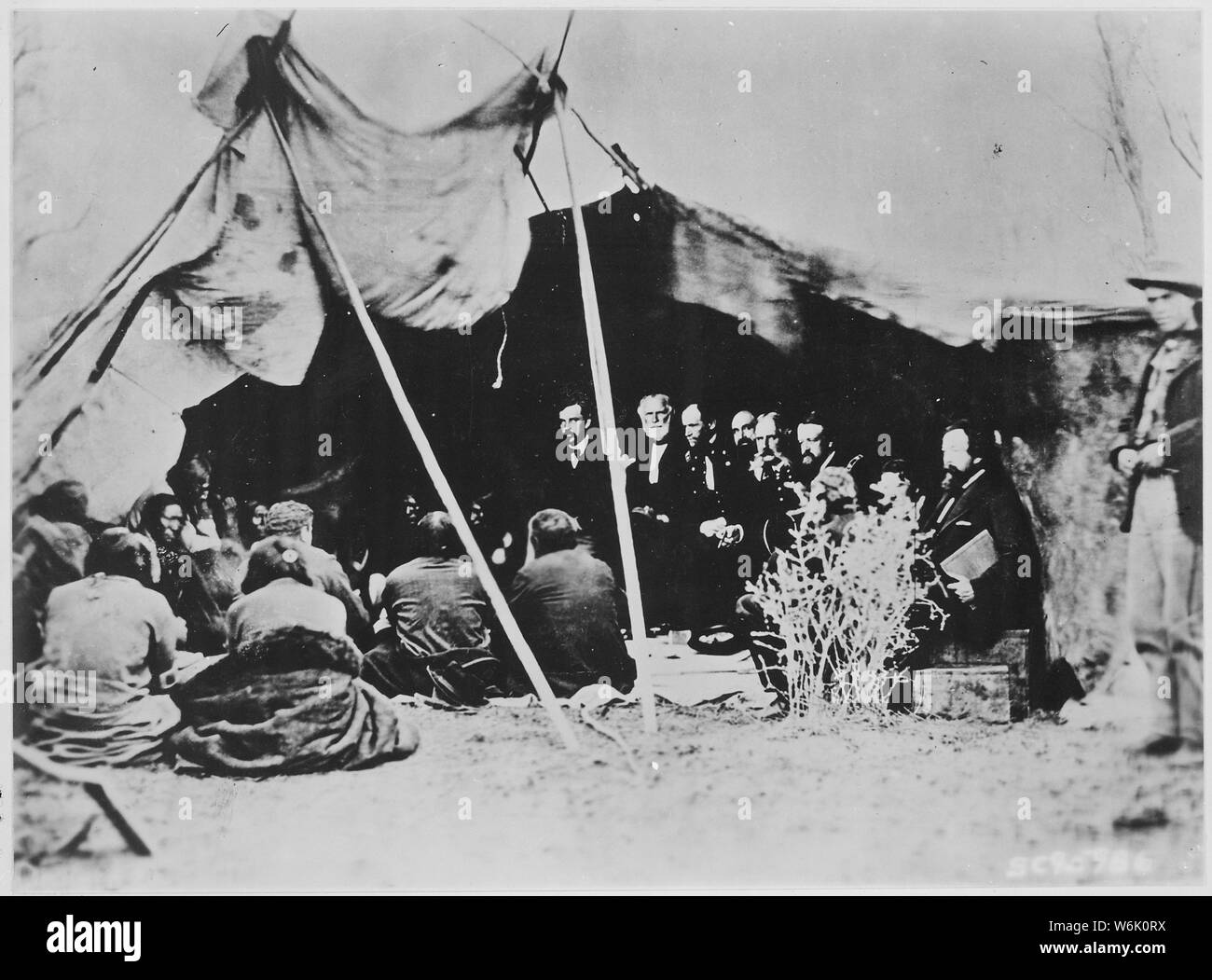 Photograph of General William T. Sherman and Commissioners in Council with Indian Chiefs at Fort Laramie, Wyoming, ca. 1868; Scope and content:  This item shows the signing of a peace treaty by William T. Sherman and the Sioux at Fort Laramie, Wyoming. Stock Photo