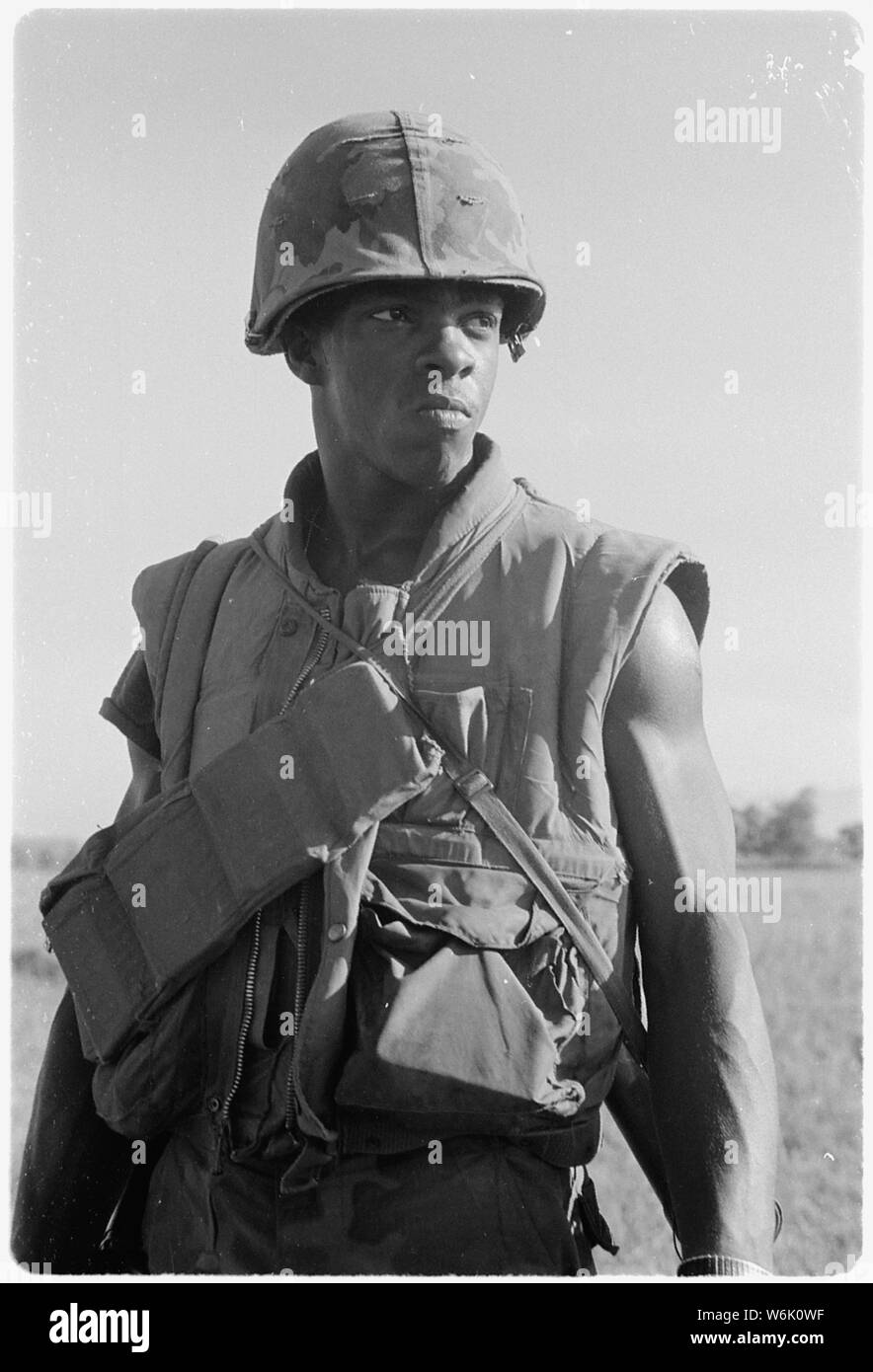 Photograph of Marines of Company I in Vietnam; Scope and content:  Original caption: Vietnam....Marines of Company I, 3rd Battalion, 1st Marine Regiment, Cross an open field while on patrol 8 miles south of the city of Da Nang. Stock Photo