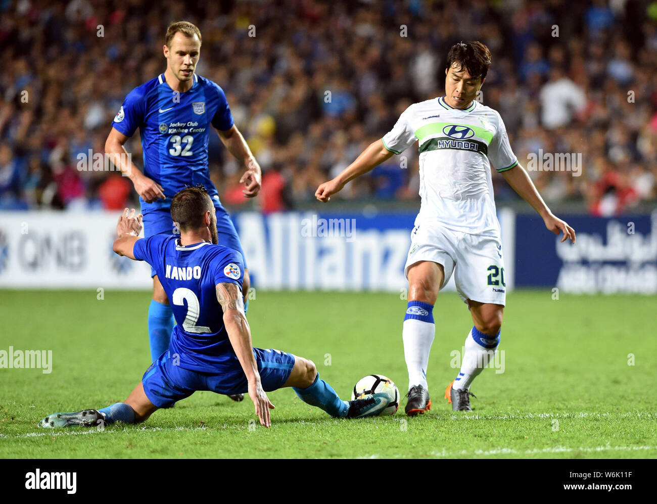 Lee Dong Gook Right Of South Korea S Jeonbuk Hyundai Motors F C Kicks The Ball To Make A Pass Against Hong Kong S Kitchee Sc In The Group E Match D Stock Photo Alamy
