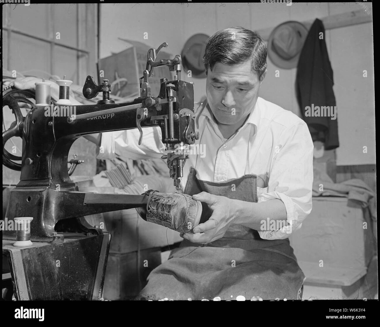 Poston, Arizona. J.K. Honda, shoe maker in the Shoe Repair shop Stock