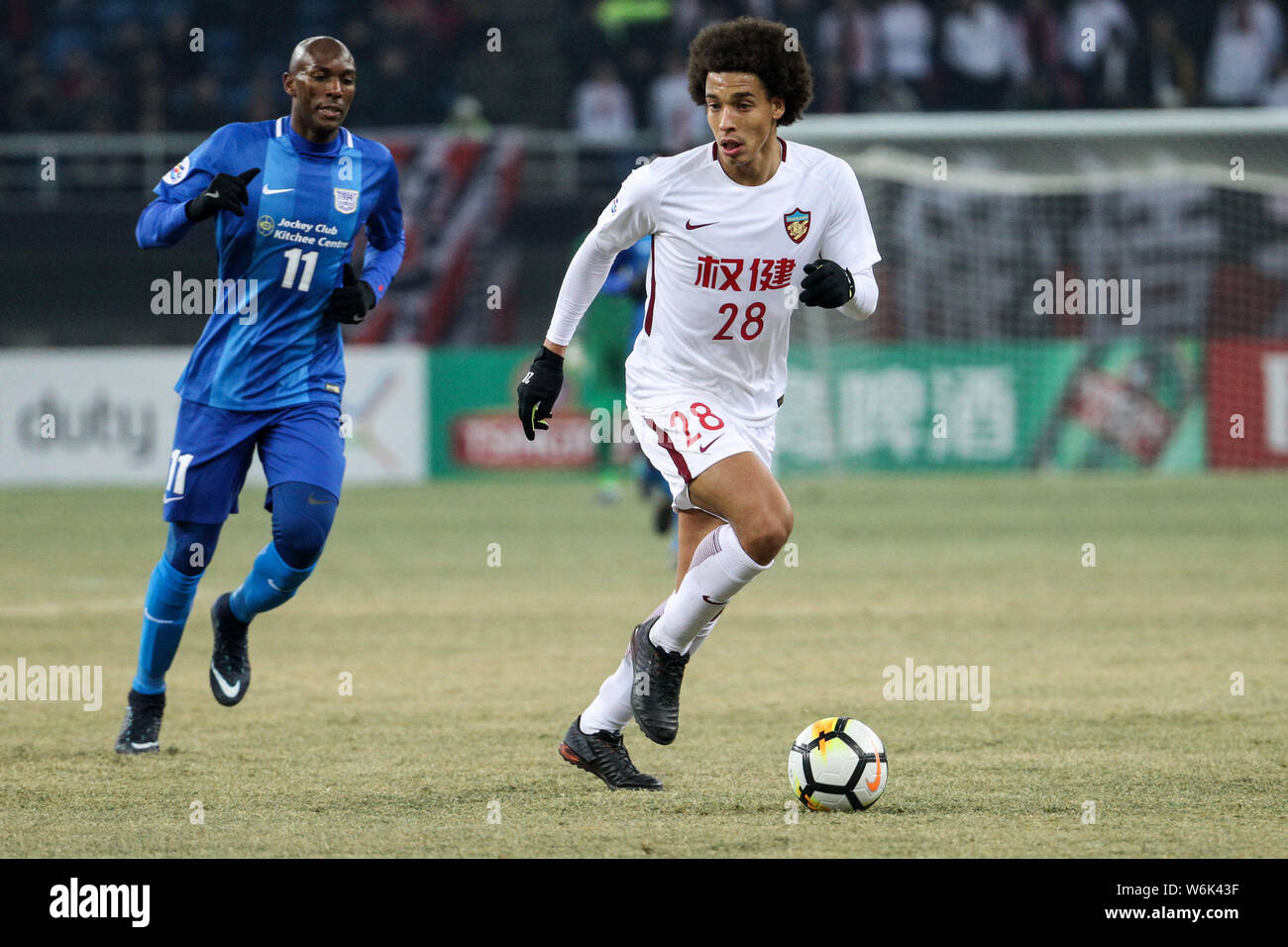 Belgian football player Axel Witsel, right, of China's Tianjin Quanjian dribbles against Hong Kong's Kitchee SC in their Group E match during the 2018 Stock Photo