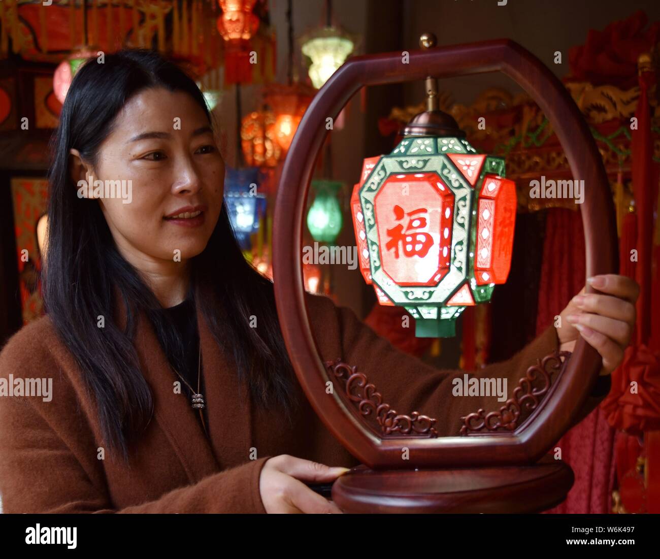 Chinese craftsman Chen Caiping shows a lantern made by herself for the ...