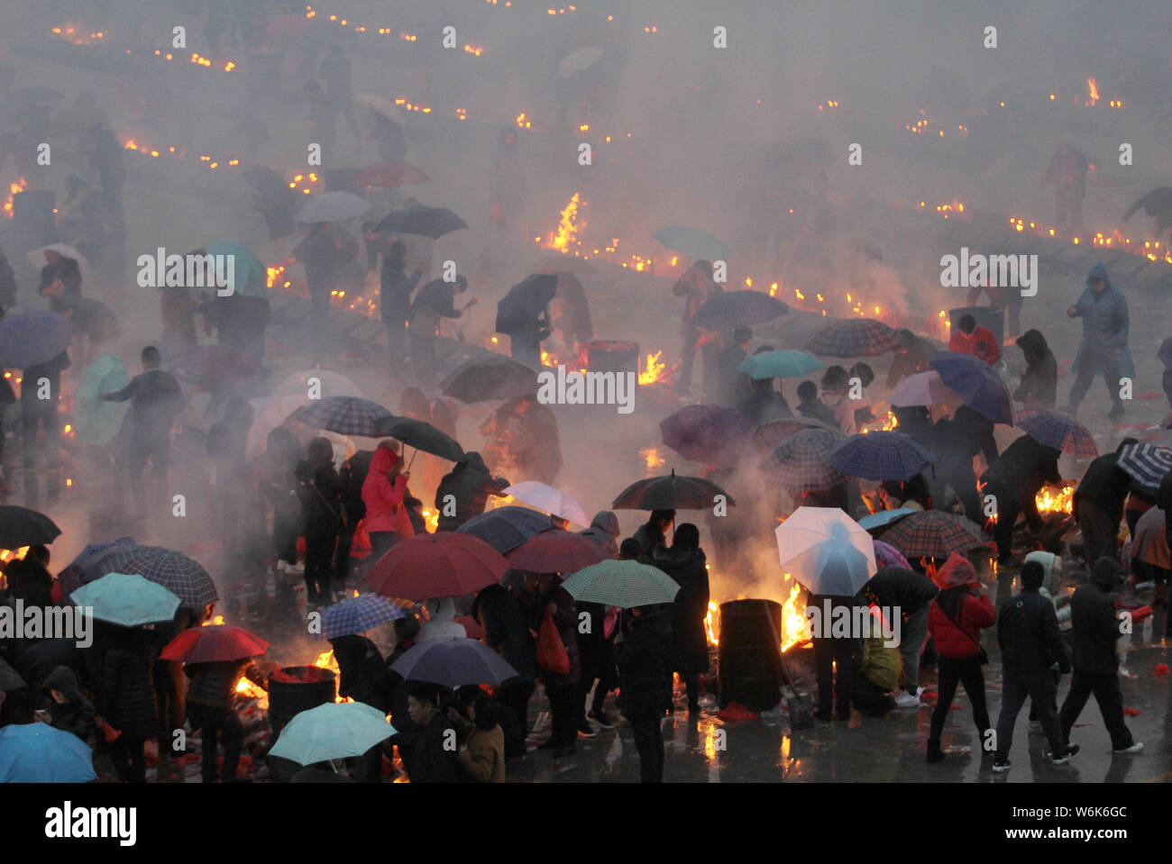 Chinese worshippers burn incense sticks to pray for wealth and ...